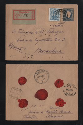 1891 - Carta Registada/Inteiro Postal - Envelope - usado de Alcains para Barcelona (Espanha). Com selo adicional de 50r. Carimbo de chegada no verso. Em boas condições.
